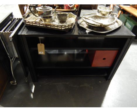 An ebonised extending low shelf unit, together with a black and chrome folding trolley.