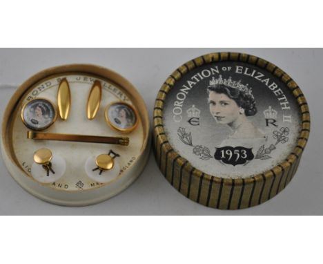 An Elizabeth II coronation gilt metal cufflink, tie clip and stud set, lion brand in original circular card box.