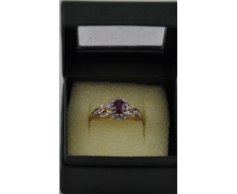 A ruby and diamond dress ring, on a 9ct gold band, 4g.