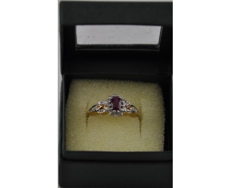 A ruby and diamond dress ring, on a 9ct gold band, 4g.