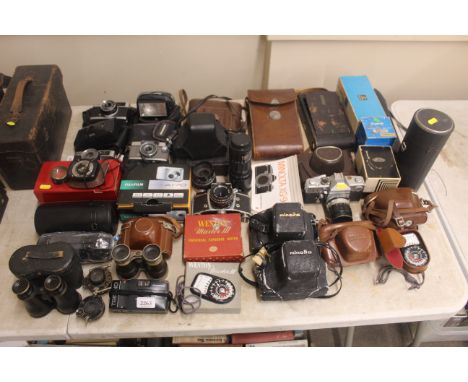 A large collection of various cameras and equipment to include Minolta, Ross Ensign, Kodak, Petri, Yashica, and many others, 