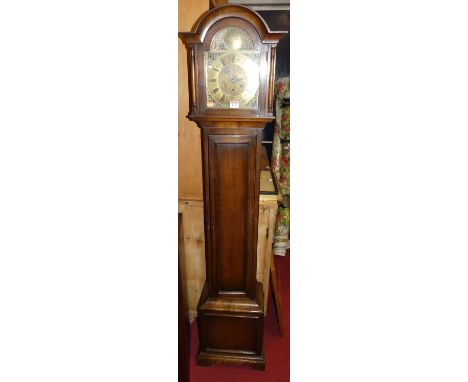 A 1930s oak grandmother clock, having an arched brass dial, striking and chiming movement, with pendulum, h.161.5cmCondition 