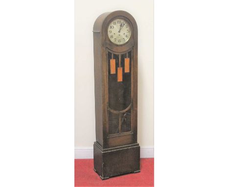 A 1930s oak longcase clock, having a circular brushed dial, with striking and chiming movement, glazed trunk door, with pendu