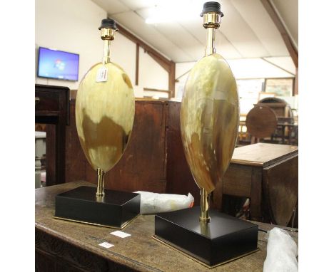 A pair of contemporary marble effect table lamps with cylindrical shades, the columns of elliptical form and raised on integr