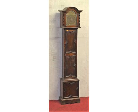A 1930s moulded oak Tempus Fugit grandmother clock, having an arched brass dial, with striking and chiming movement, geometri