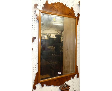 A contemporary yew wood fret carved wall mirror in the Chippendale style, with bevelled rectangular plate, 99 x 58cm 