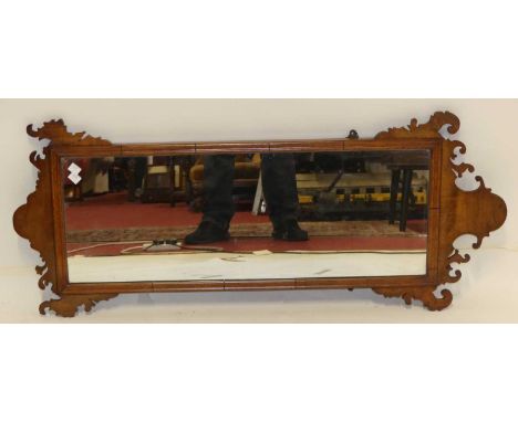 An early 20th century figured walnut cushion framed and fret carved rectangular wall mirror in the Chippendale taste, 108 x 4