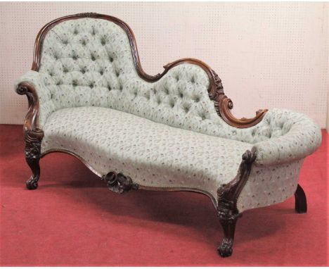 A mid-Victorian floral carved rosewood framed scroll-end sofa, having floral buttoned upholstery, raised on scroll cabriole s