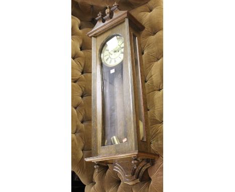An oak drop trunk wall clock, the circular enamel dial with monogram for Gustav Becker, with two weights and pendulum, height