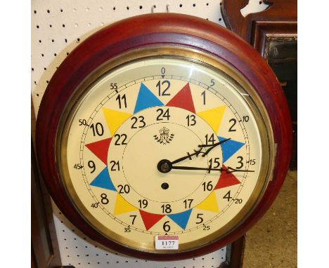 A reproduction circular stained wood wall clock, bears RAF painted insignia, dia.33cm