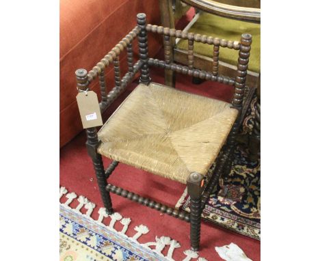 An early 20th century bobbin turned walnut rush seat corner chair, together with an early 20th century oak barley twist singl