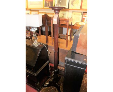 An early 20th century mahogany stop fluted standard lamp, raised on hipped supports, height 166cm