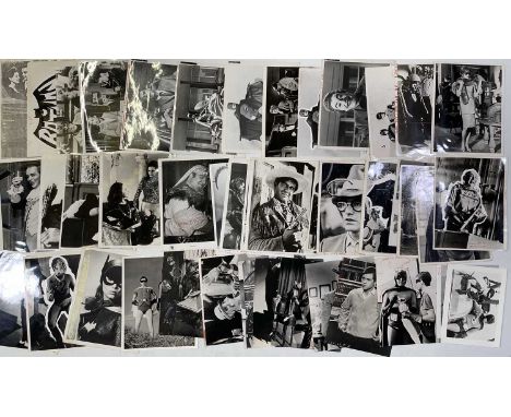 Approx 47 variously sized (many c 8x10") black and white press photographs depicting stills from the c 1960s Burt West/Adam W