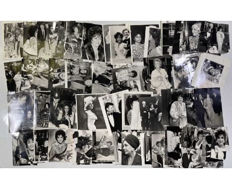 Approx 105 variously sized (many c 8x10") black and white press photographs depicting Elizabeth Taylor, many vintage prints w