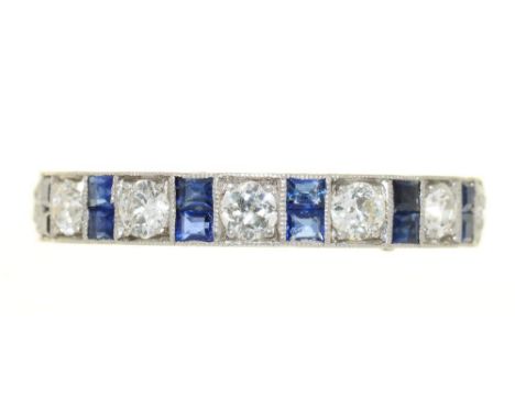 AN ART DECO MILLEGRAIN SET CALIBRE SAPPHIRE AND BRILLIANT CUT DIAMOND ETERNITY RING, ENGRAVED PLATINUM HOOP, 4G, SIZE P½++GOO