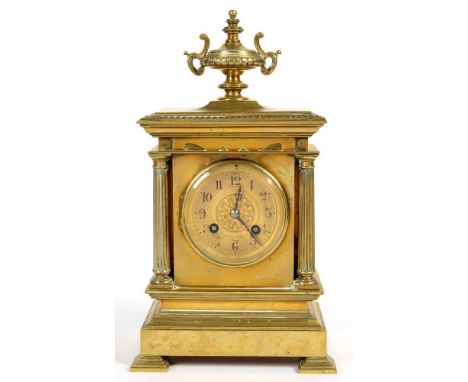 A FRENCH ARCHITECTURAL STYLE BRASS MANTEL CLOCK, THE PILLARD CASE WITH URN FINIAL, THE MOVEMENT STRIKING ON A COILED WIRE GON