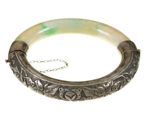 A CHINESE JADE AND FOLIATE CHASED SILVER HINGED BANGLE ++TARNISH AND WEAR CONSISTENT WITH AGE 
