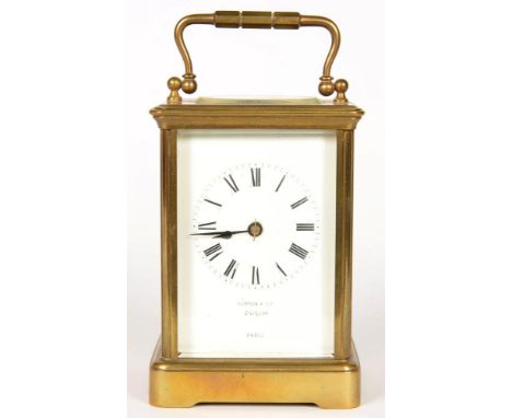 A FRENCH BRASS CARRIAGE CLOCK, THE ENAMEL MASK DIAL INSCRIBED AUSTIN &amp; CO DUBLIN PARIS, THE MOVEMENT WITH REPLACEMENT PLA