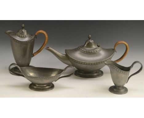 A Liberty Tudric Pewter Arts and Crafts period four-piece tea service, comprising teapot, water jug, milk jug and sugar basin