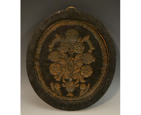 Treen and Kitchenalia - a black wax oval gingerbread mould, in intaglio with a Baroque flowering vase, 25cm long 