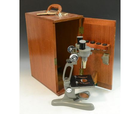 A Beck Binomax jug-handled stereo microscope, two reversible objectives, grey finish, 34cm high, fitted mahogany case, c.1950