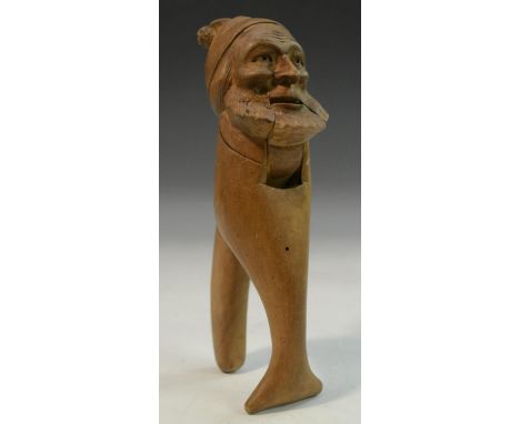 A Black Forest novelty nut cracker, carved as the head of a bearded man, 17.5cm long, c.1900