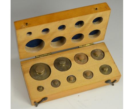 A set of brass scientific scale weights, from 100 to 1g, fitted beech case, 14cm wide overall