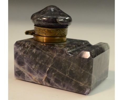 An early 20th century amethyst quartz desk inkwell, hinged cover, the rectangular base with pen rest, 7cm long