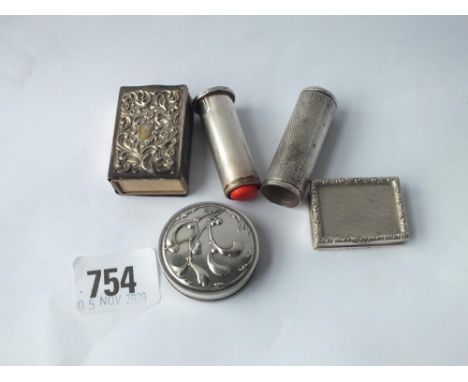 An embossed matchbox holder, 1904 - a pill box, 1926 - a continental measuring tape holder and a lipstick holder - both unmar