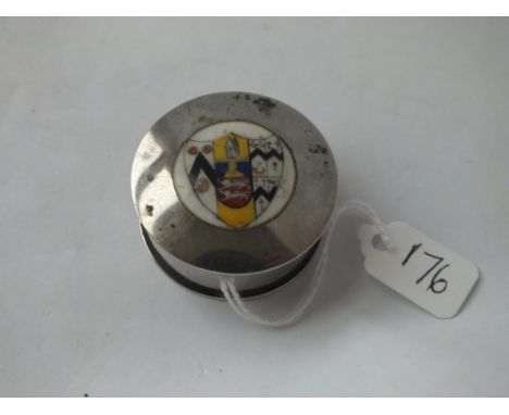 A silver circular vintage pill box with enamel heraldic shield to top 