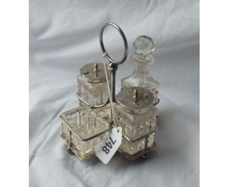 A four-piece cruet set with cut glass body and central ring handle - Sheffield 1901