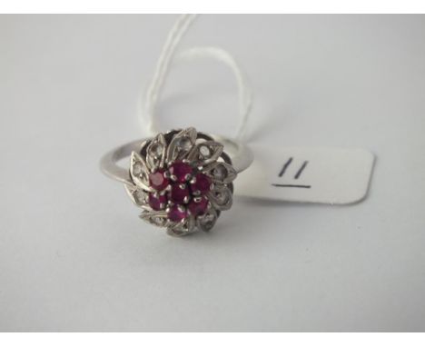 A white gold ruby cluster ring in 18 ct gold - Size N - 3.4gms.