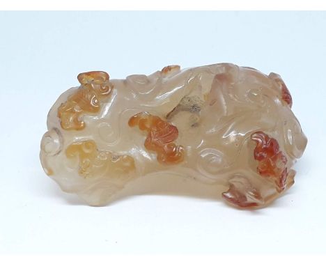A Chinese celadon jade carving depicting bats, a cloud and a dragon, length 8cm.Condition:- Appears to be be areas of losses 
