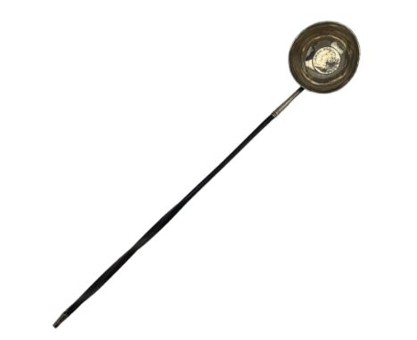 19th century toddy ladle, the circular bowl set with a Queen Anne coin and on a twisted handle