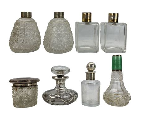 Silver mounted glass scent bottles and jars including a pair of rectangular form glass jars with plain and engine turned silv
