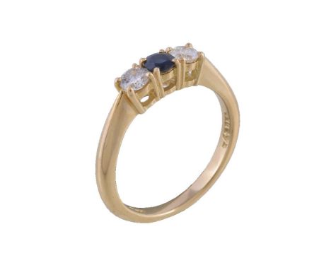 A sapphire and diamond ring, the central circular cut sapphire claw set between two brilliant cut diamonds, approximately 0.2