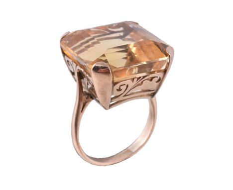 A 1960s citrine dress ring, the rectangular fancy cut citrine in a four claw setting, stamped 14ct, finger size M