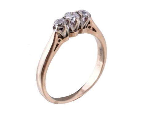 A diamond three stone ring, set with three brilliant cut diamonds, approximately 0.20 carats total, in claw settings, stamped