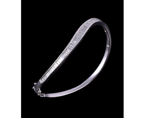 A diamond set hinged bangle, the curved bangle set with graduating baguette cut diamonds, approximately 1.78 carats total, st