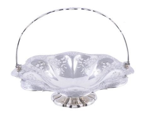 A Victorian silver shaped circular swing handled pedestal basket by Henry Wilkinson & Co., Sheffield 1859, the swing handle e