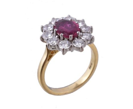 A ruby and diamond cluster ring, the oval cut ruby within a surround of brilliant cut diamonds, approximately 1.20 carats tot
