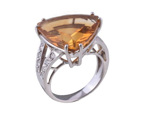 A citrine and diamond dress ring, the fancy cut citrine claw set between brilliant cut diamond set shoulders, approximately 0