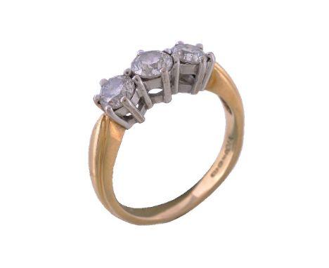 A diamond three stone ring, set with three brilliant cut diamonds, approximately 0.70 carats total, in claw settings, stamped