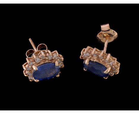 A pair of sapphire and diamond cluster ear studs, the oval cut sapphires within a surround of brilliant cut diamonds, approxi