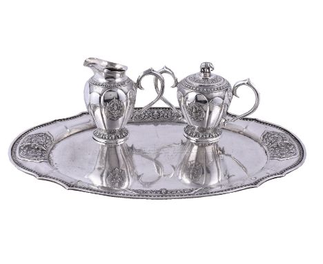 A Thai silver coloured tray, cream jug and sugar basin by Thai Nakon, Bangkok, .925 standard, circa 1967, the shaped oval tra