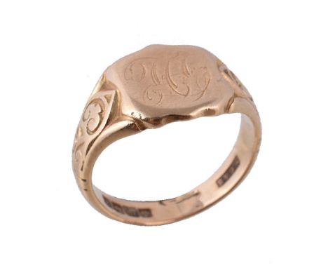 An 18 carat gold signet ring, the shield shaped panel to scrolled shoulders, hallmarked Birmingham 1922, makers mark H C & S,