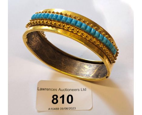 Victorian gilt metal and turquoise set bangle, the internal measurements approximately 55mm x 47mm (one stone missing) 