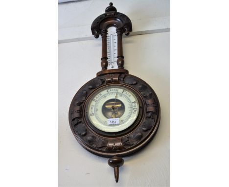Circular carved walnut banjo aneroid barometer/ thermometer, together with a similar mahogany barometer 