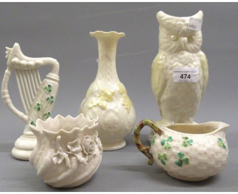 Five various items of Belleek including an owl form vase, a harp etc. 