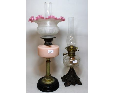 Victorian brass oil lamp, with peach glass well and etched shade, together with another iron and clear glass oi lamp with chi